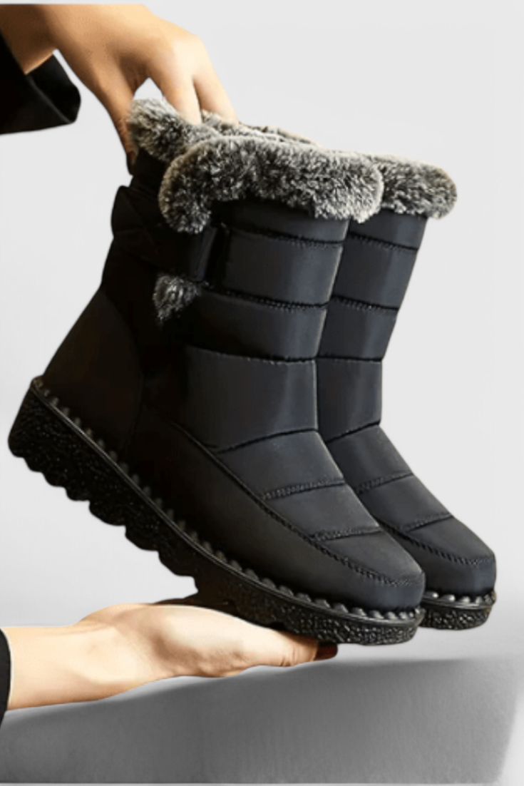 Lexiβ’ women's black waterproof mid-calf boots with slip-resistant sole and sleek polished silhouette