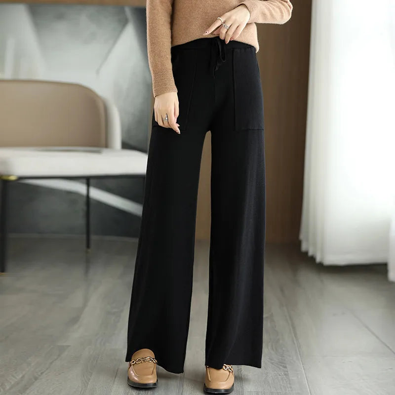 High waisted wide-leg wool pants in neutral tone with relaxed silhouette and flattering waistband