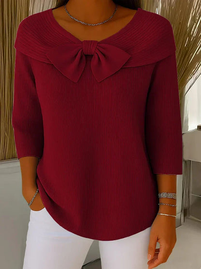 Soft feminine sweater with delicate bow accent detail, elegant chic style in violet hue