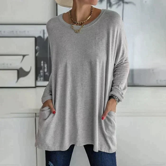 Women's oversized long sleeve tunic top with front pockets, relaxed knit fit and flared hem