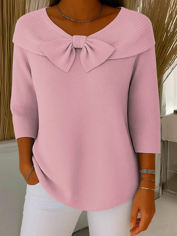 Soft feminine sweater with delicate bow accent detail, elegant chic style in violet tones