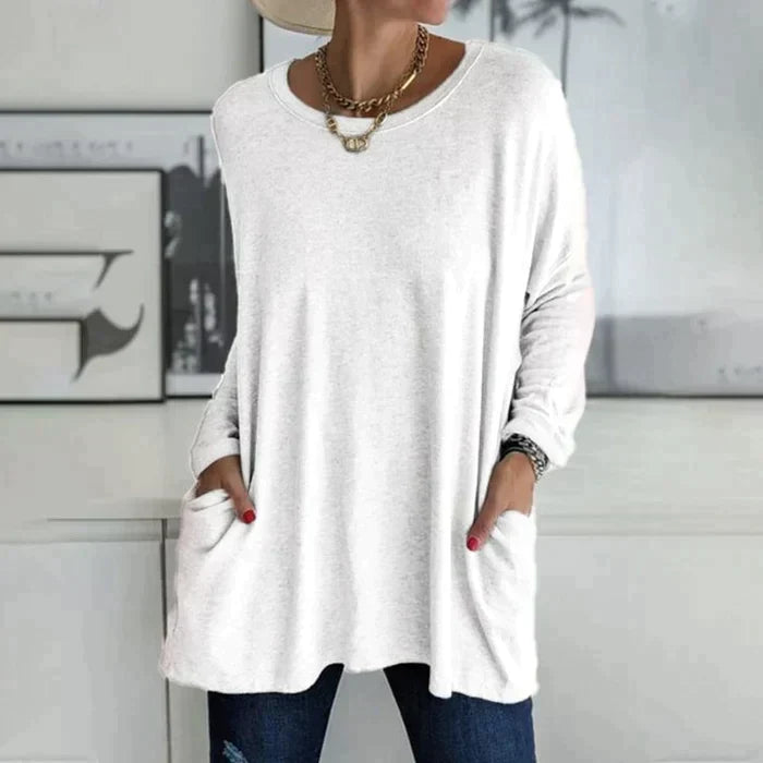 Women's oversized long sleeve tunic top with front pockets, relaxed knit fit and flared hem