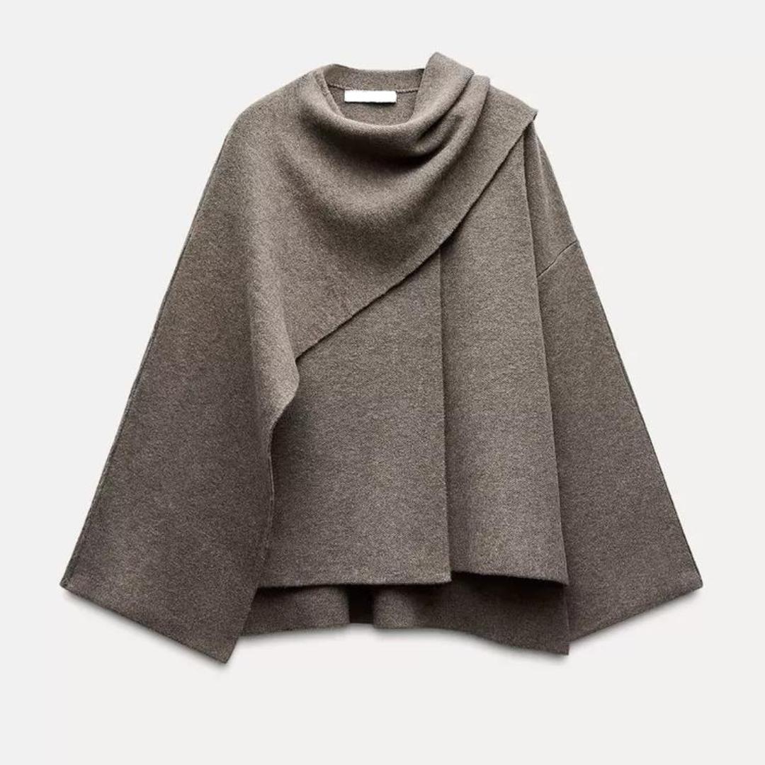 Elegant draped cape mantel in flowing silhouette with refined tailoring for versatile layering