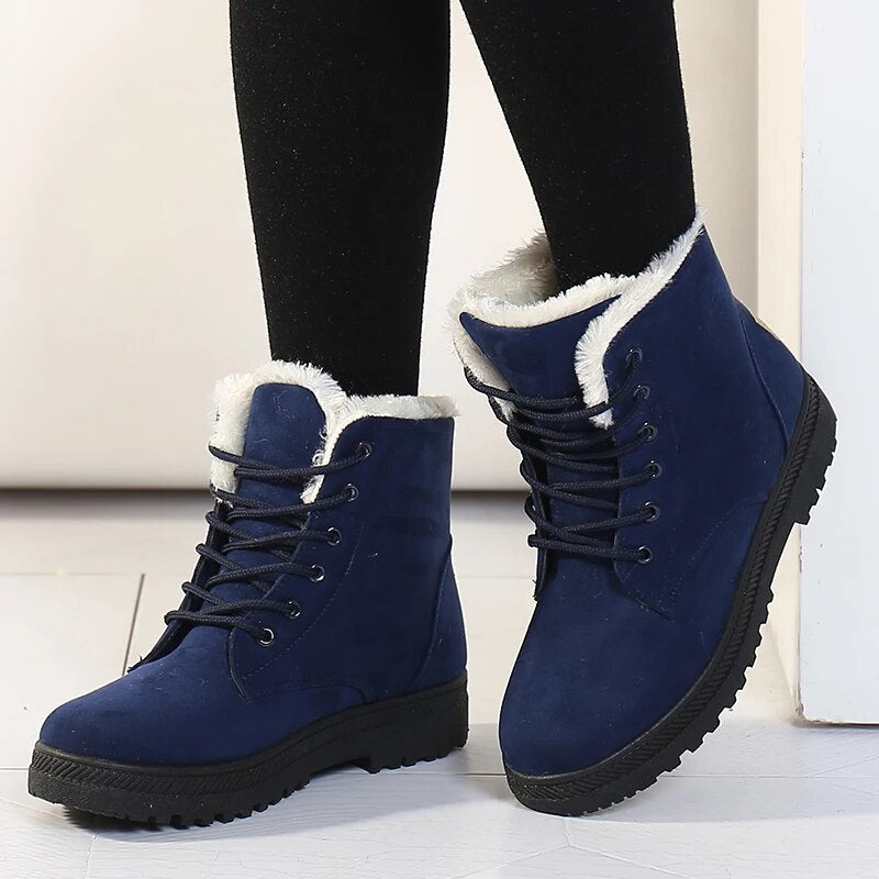 Women's short ankle boots in warm tones with plush interior lining, sleek silhouette, winter-ready style
