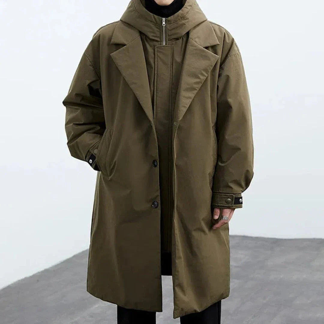 Oversized hooded trench coat in neutral tone with detachable hood and mid-thigh windbreaker silhouette