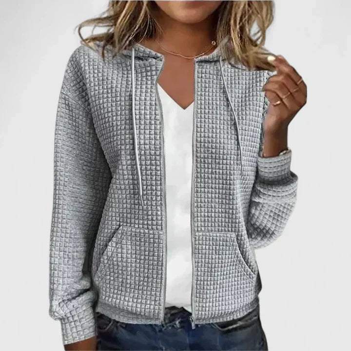 Elegant relaxed-fit cardigan in soft neutral tones with breathable fabric and flattering silhouette