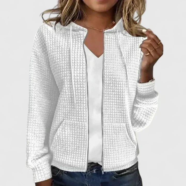 Elegant relaxed-fit cardigan in soft neutral tones with a breathable layering design for effortless style