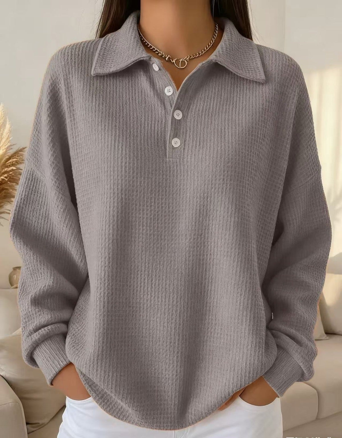Textured polo sweater in neutral tone with classic knit pattern and refined polo collar