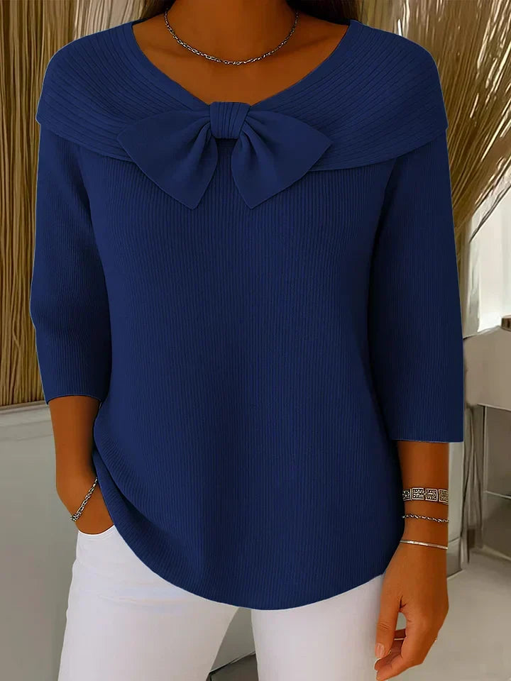 Women's round neckline sweater with delicate bow accent, soft feminine style for effortless layering