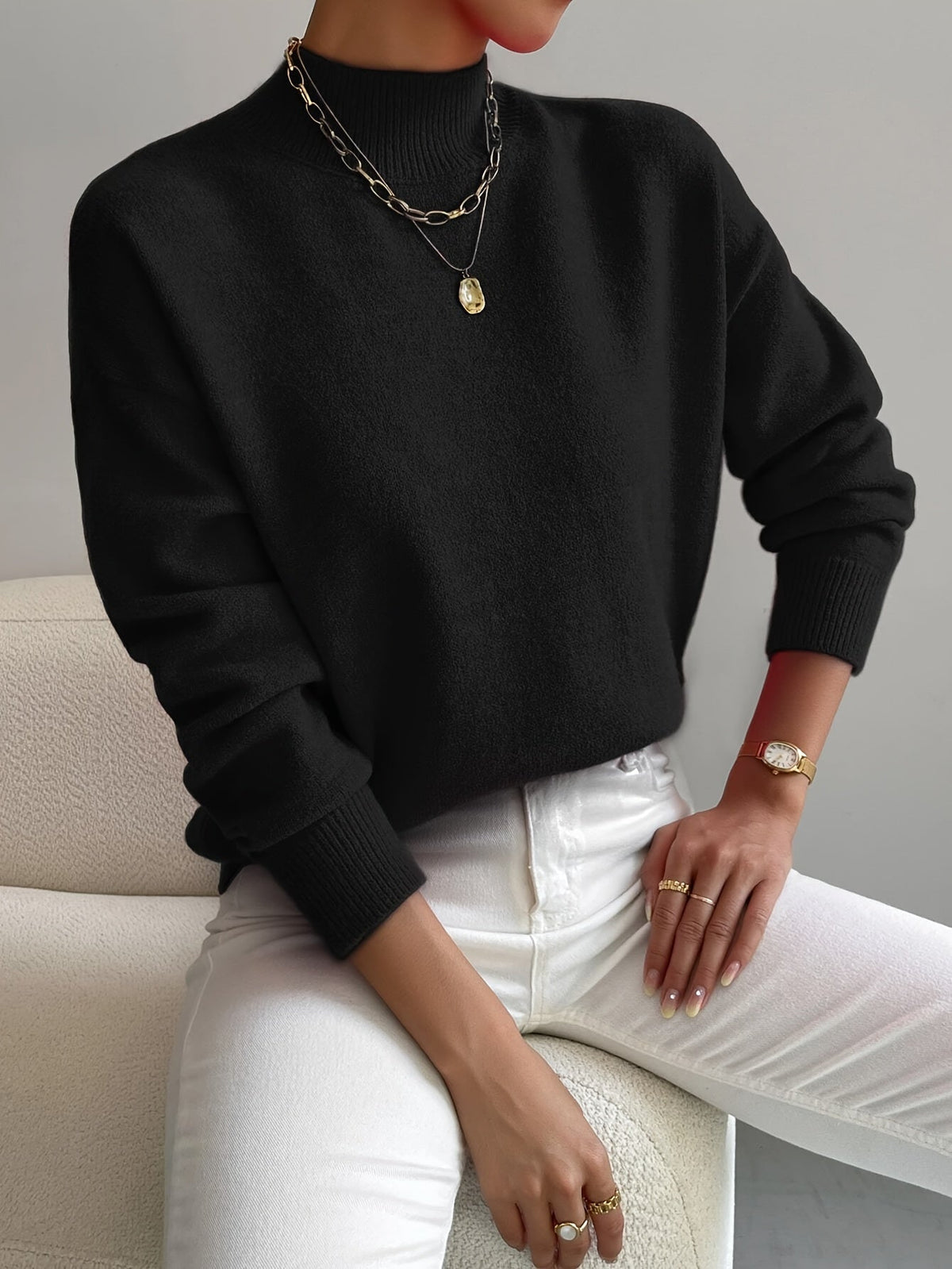 Elegant cream turtleneck sweater with flattering fitted cut and elongating neckline design
